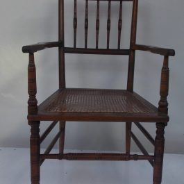 Antique Wooden Armchair With Cane Seat And Rustic Carved Design